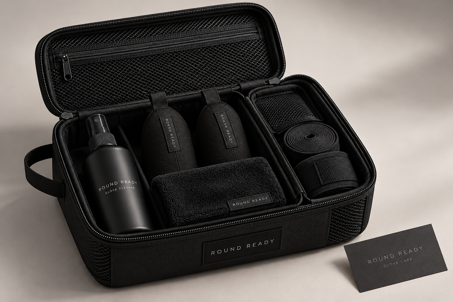 Round Ready concept: open black organiser holding cleaner, two fabric glove inserts and a cloth, with a separate compartment for rolled hand wraps.